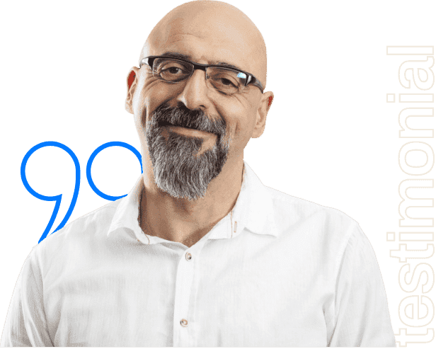 Smiling man with a grey goatee and glasses