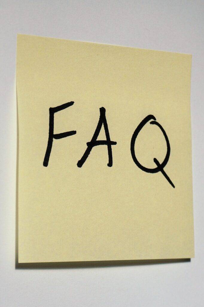 A yellow square sticky note with the acronym FAQ